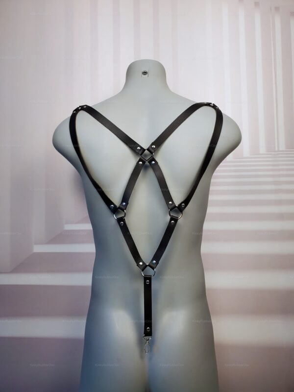 Front view of black faux leather body harness with adjustable straps and three metal suspender clips, designed for bold fashion and kink wear.