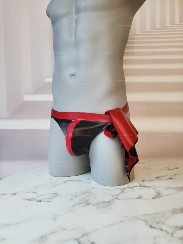 Red and black latex jockstrap with a removable front flap, designed for adventurous fashion.