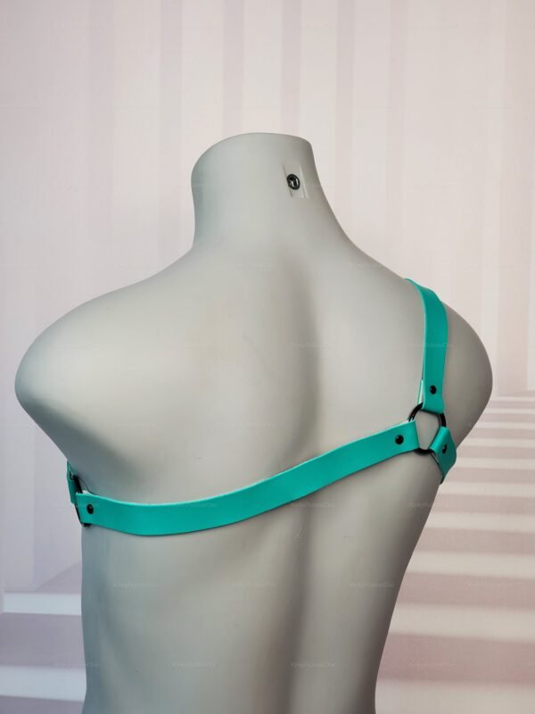 Teal latex spike chest harness with black hardware, designed for bold fashion statements.