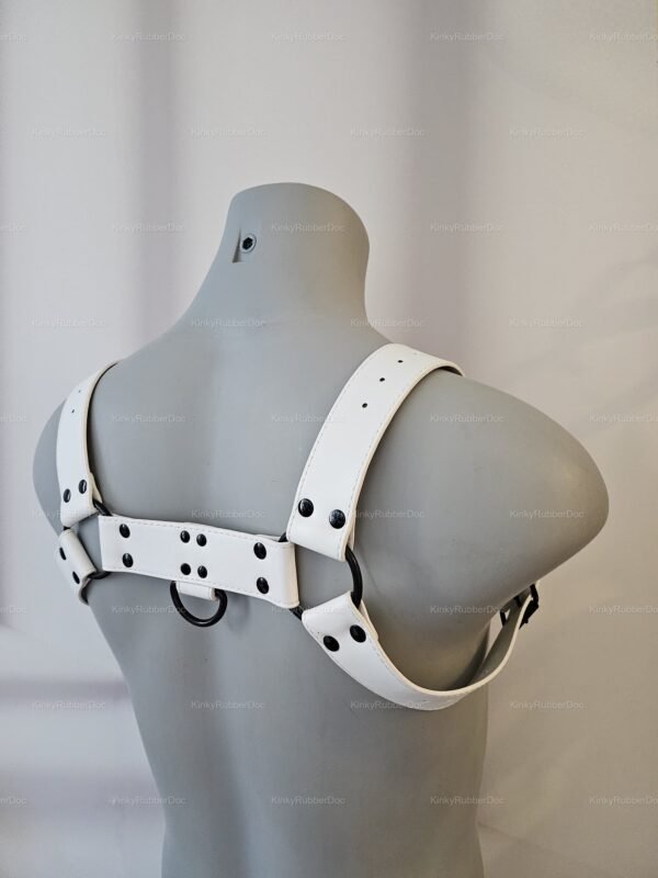 White leather-look harness with adjustable straps and metal rings, designed for bold and stylish expression.
