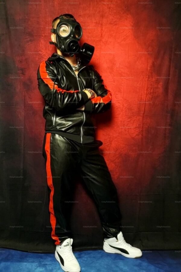 Black and red leather tracksuit with bold stripes and edgy gas mask accessory.