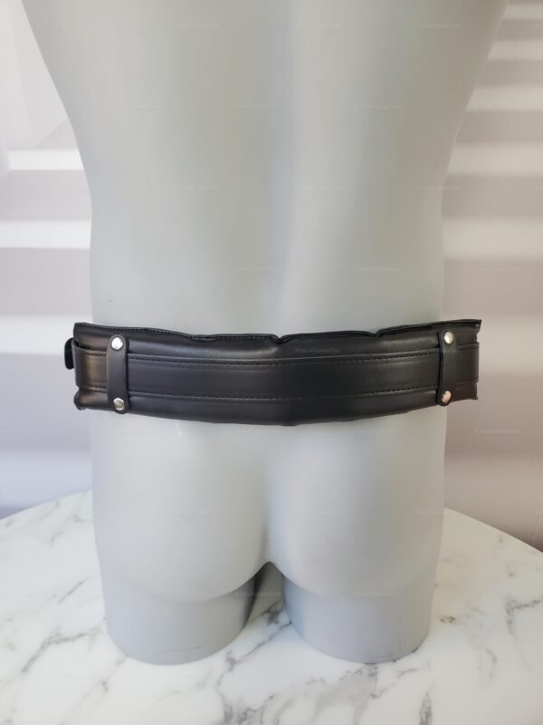 Black padded leg sling restraints with rivet details on a marble surface.