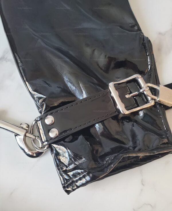 Shiny black PVC mitt restraints with sturdy leather straps and metal buckles.