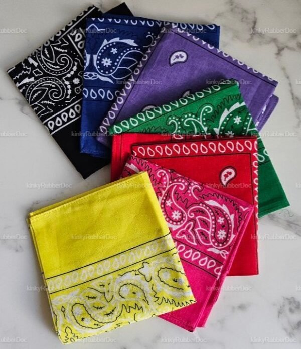 A collection of colorful bandanas in black, blue, purple, green, red, pink, and yellow with paisley patterns.