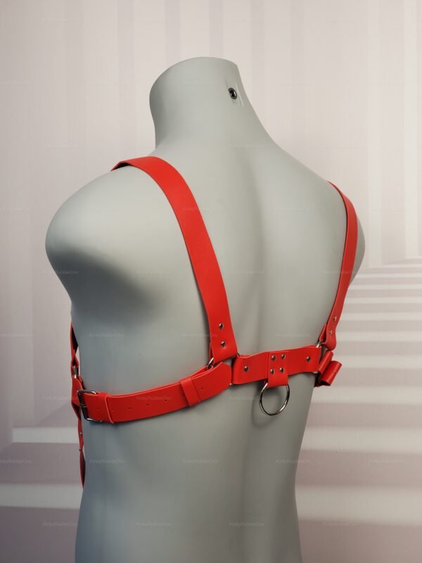 Back view of red faux leather chest harness with adjustable straps and rear D-ring, queer kink gear