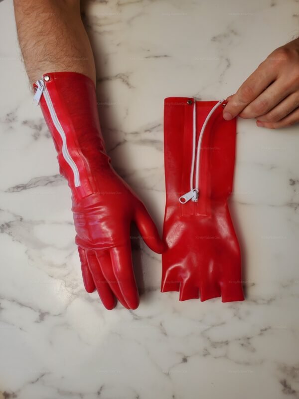 Red latex gloves with white zippers and a glossy finish, designed for a bold and adventurous look.