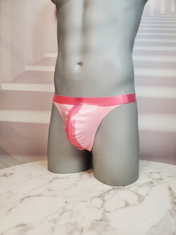 Pink rubber thong with glossy finish on a marble surface.