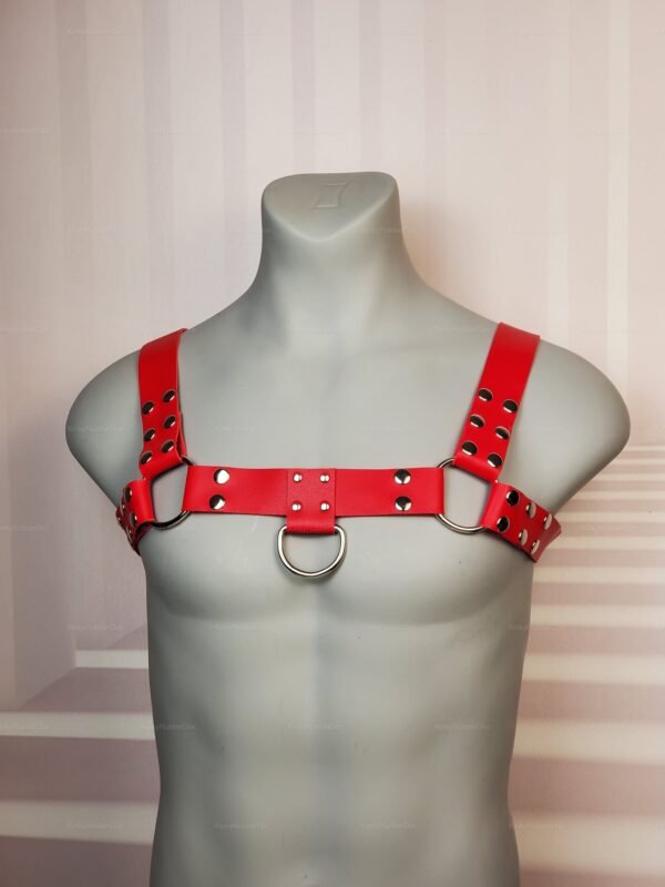 Red leather unisex chest harness with silver D-rings and snap rivet details, queer kinkwear