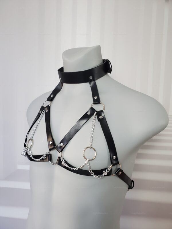 Black unisex harness with metal rings and chains.