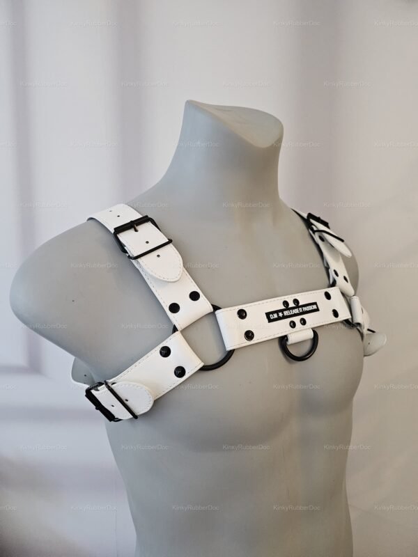Sleek white vegan harness with black ring accents and adjustable buckles.