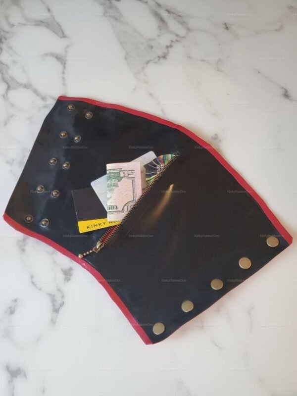 Black latex wrist cuff with red trim and a discreet zippered pocket for storage.