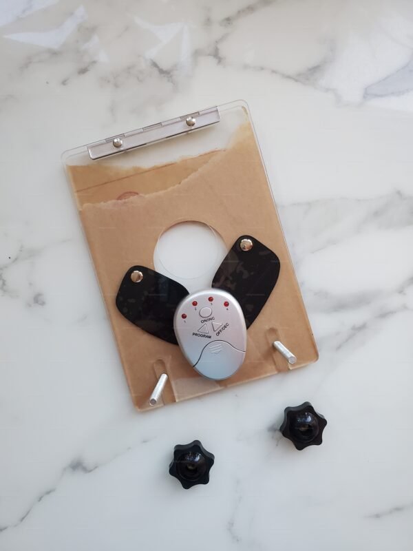 Electro Ball Crusher Device with adjustable knobs and sleek design on a marble surface.