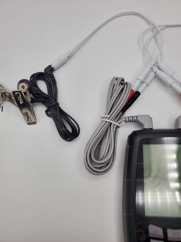 Close-up of a BDSM electro toy controller box with attached cables and metal clamps.