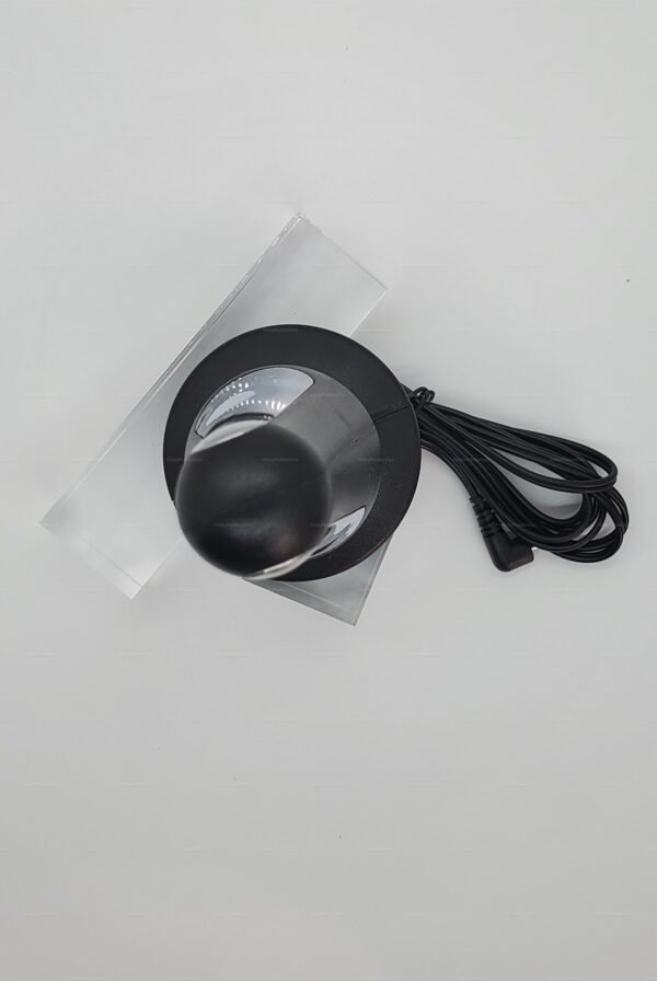 Sleek black electro-stimulation plug with a smooth, glossy finish and attached cable.