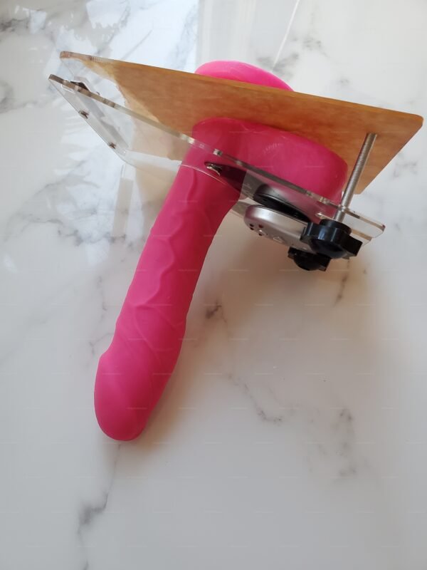 CBT plate with shock control e-stim device featuring a vibrant pink, textured design on a marble surface.