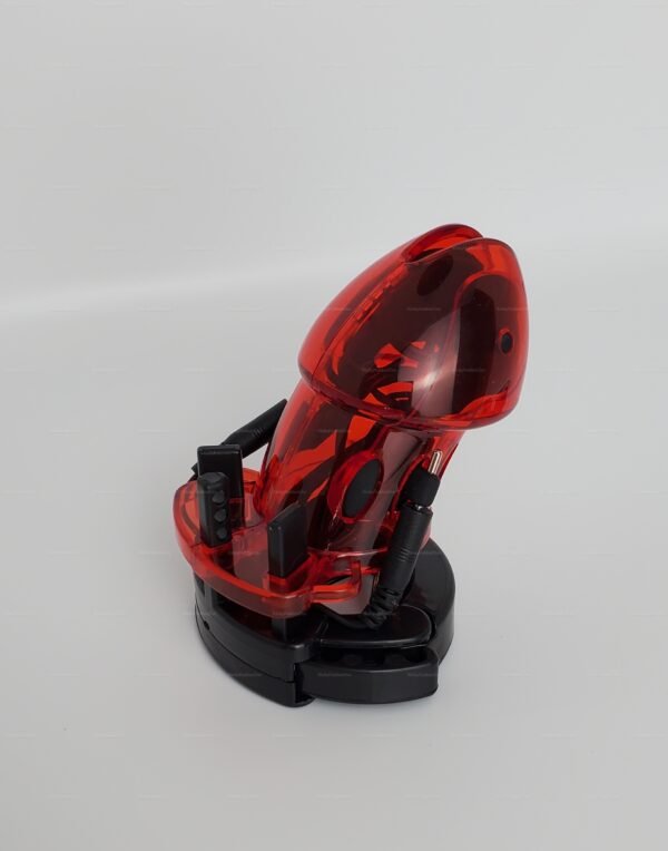 A transparent red chastity device with electro-stimulation features, designed for male tease and denial experiences.
