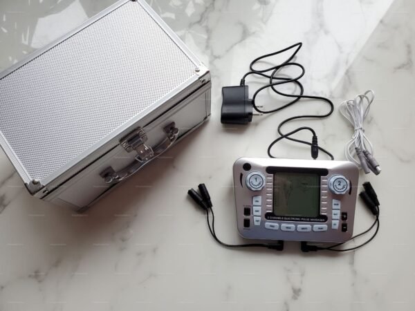Dual Channel E-Stim Device control unit with cables and a silver storage case on a marble surface.