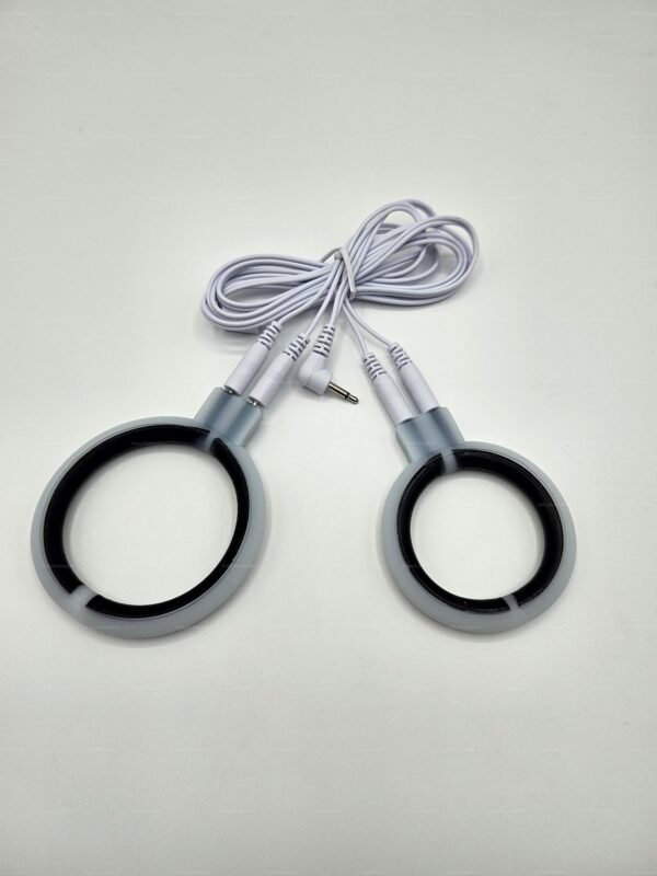 E-stim penis ball ring made of conductive rubber with connected cables for electrifying sensations.