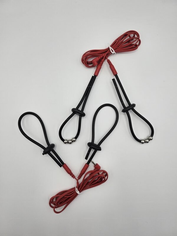 A set of electro cock ring straps by KinkyRubberDoc featuring black rubber loops and red cables for a bold, electrifying experience.