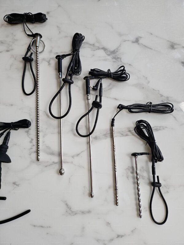A collection of sleek electro penis insertion probes and urethra sounds, featuring smooth metallic finishes and black cables.