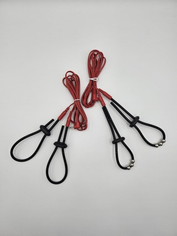 Electro-strap rings with black loops and red cords for BDSM play.