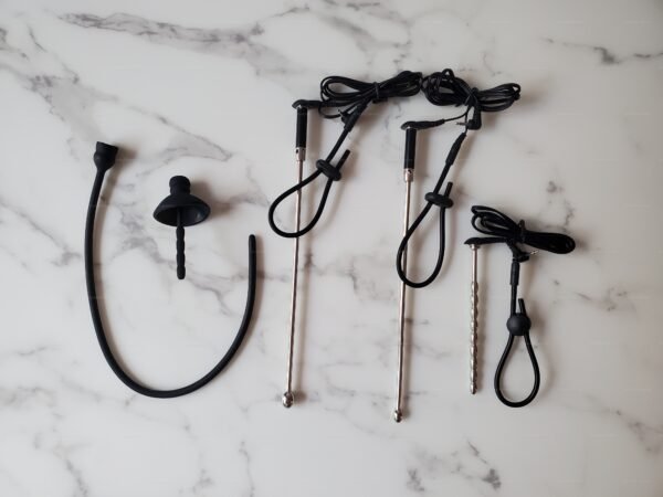 A selection of electro-urethral sounding tools for male pleasure, featuring sleek designs and various materials, ideal for the adventurous kink community.