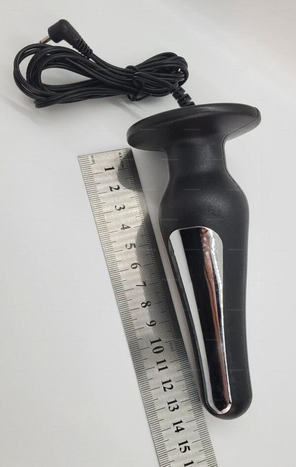 Electro-stim anal plug with a sleek black design and non-detachable cable alongside a ruler for size reference.