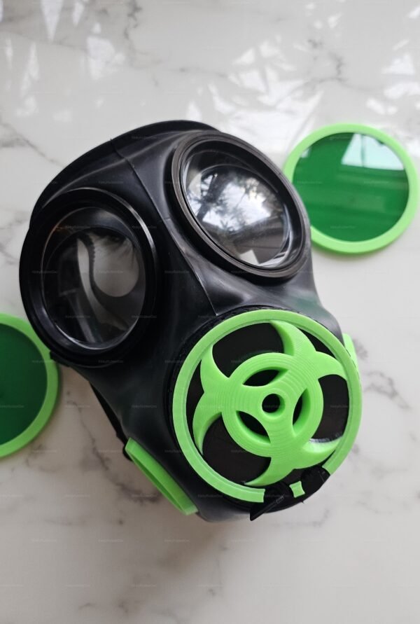 Black fetish mask with green lens and biohazard design, featuring a striking contrast and futuristic vibe.