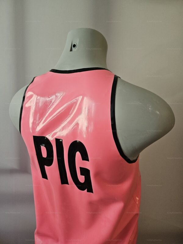 Shiny pink latex shirt with bold black lettering spelling "PIG" on the back.