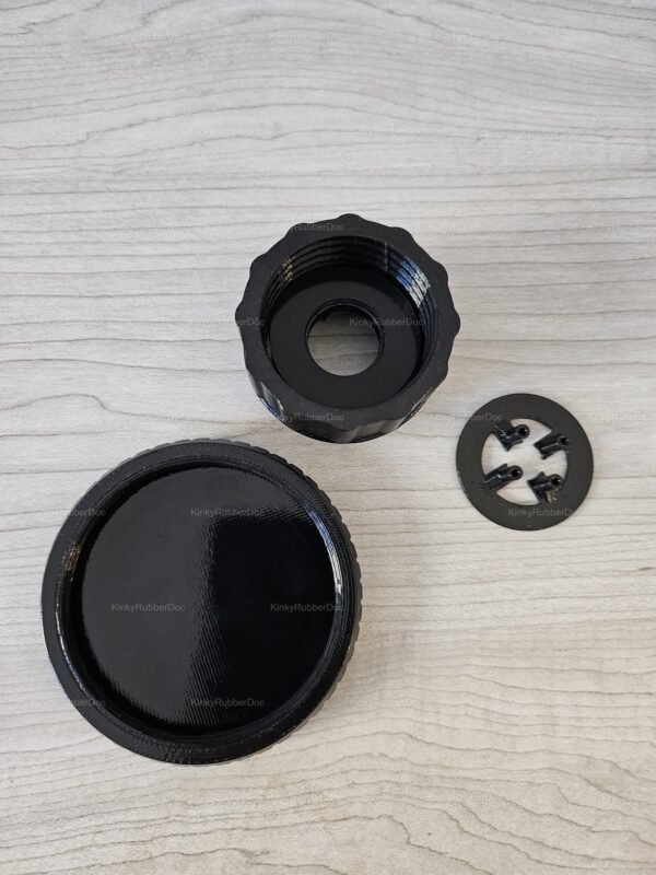 Sleek black fmj05 mask valve converter with spike ring on a textured surface.