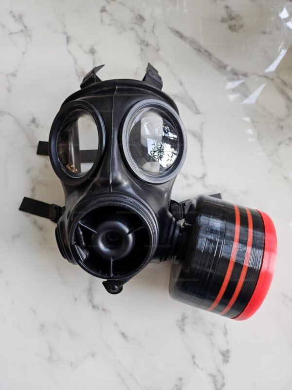 A sleek black gas mask with a bold red-striped canister, designed for hose compatibility in fetish play.