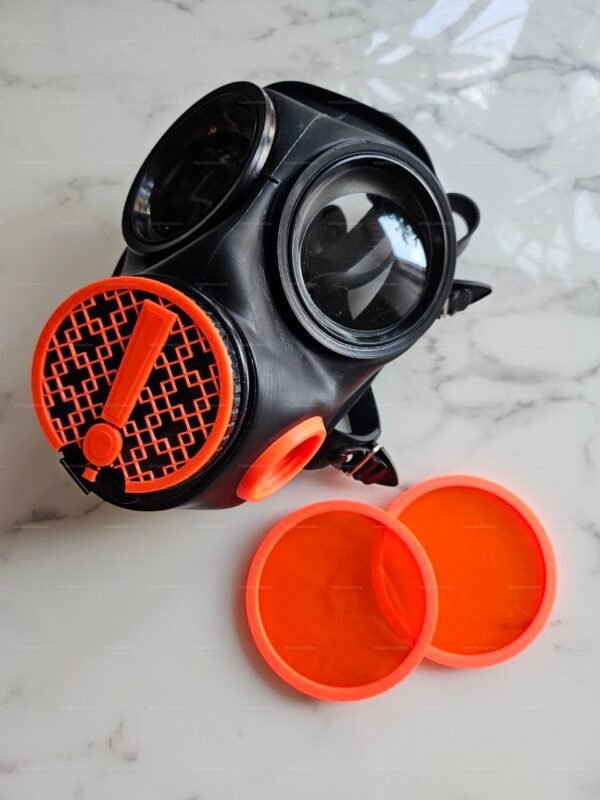 Vibrant orange-valve black party mask with interchangeable covers, ideal for a bold, edgy look.