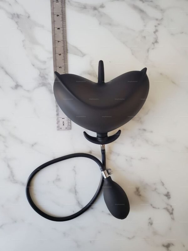 Inflating Anal Petal Plug with Detached Pump on marble surface.