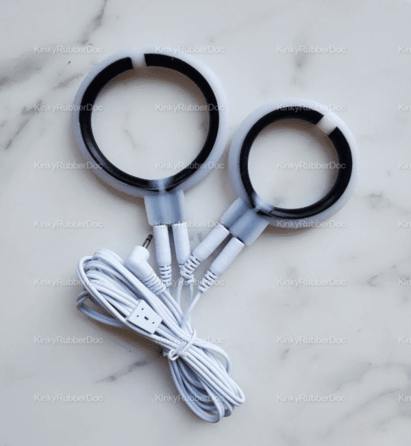 A sleek electro sex toy penis stimulator featuring two conductive rings connected by white cables, designed for a stimulating experience.