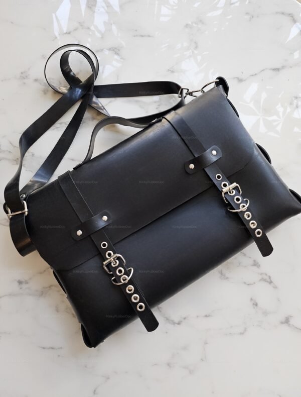 A sleek black Rubber Briefcases Bag featuring buckle details and adjustable straps, perfect for the kink community.