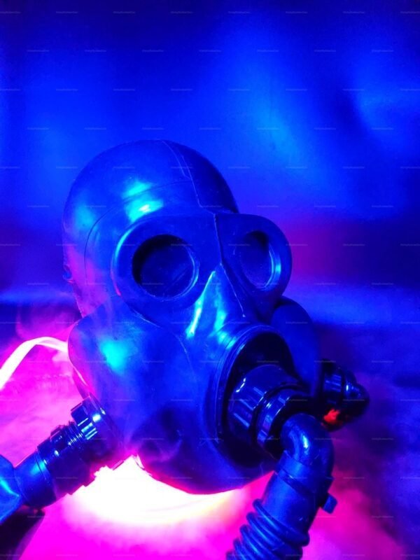 A kinky-retro-gas-mask-hood with a dual inlet design, bathed in blue and pink lighting.