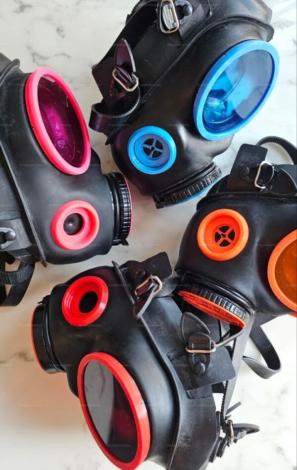 Three kinkyrubberdoc custom valve gas masks with vibrant colored lenses and detailing.