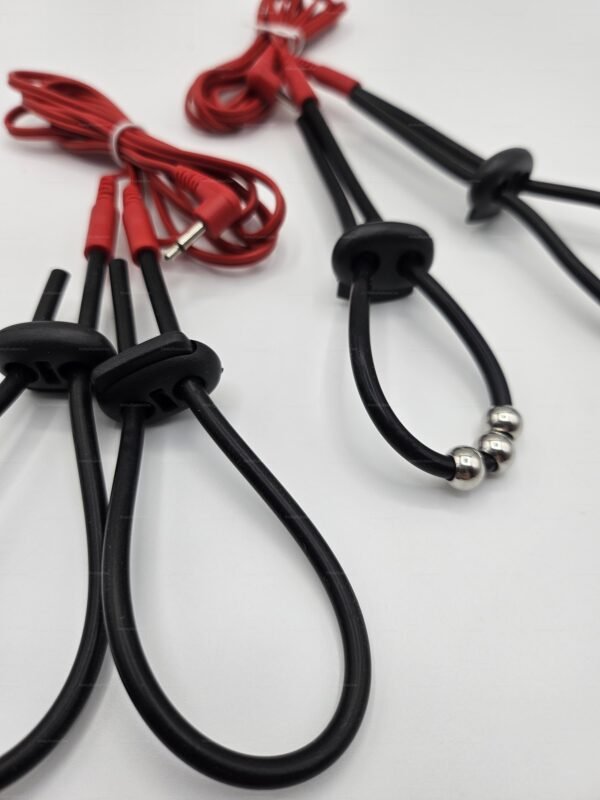 Black and red kinkyrubberdoc-penis-electro-straps with adjustable loops and connectors.