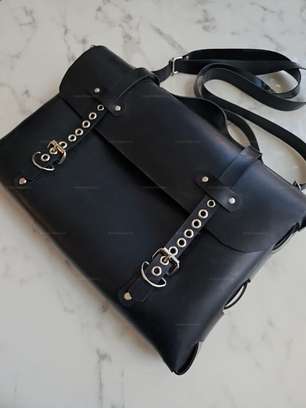 Sleek black heavy-duty latex gear bag with metal accents and adjustable straps, perfect for storing fetish accessories.