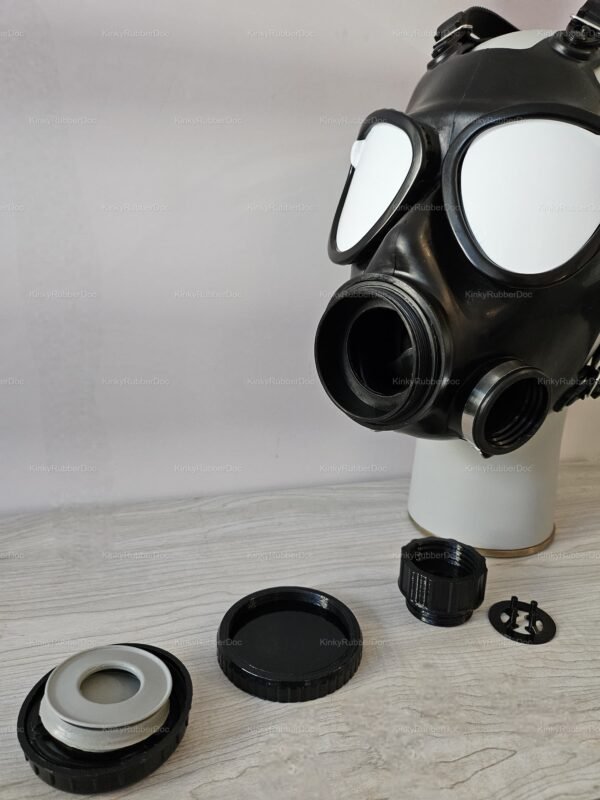 Black rubber gas mask with threaded cap components, designed for a bold and adventurous statement in fetish fashion.