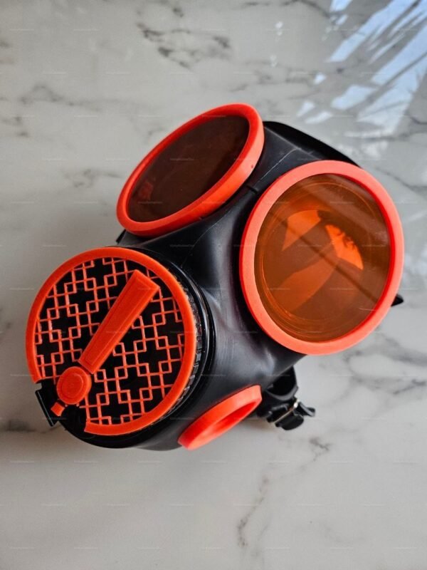 Black and orange mask with removable lenses and exclamation mark design.