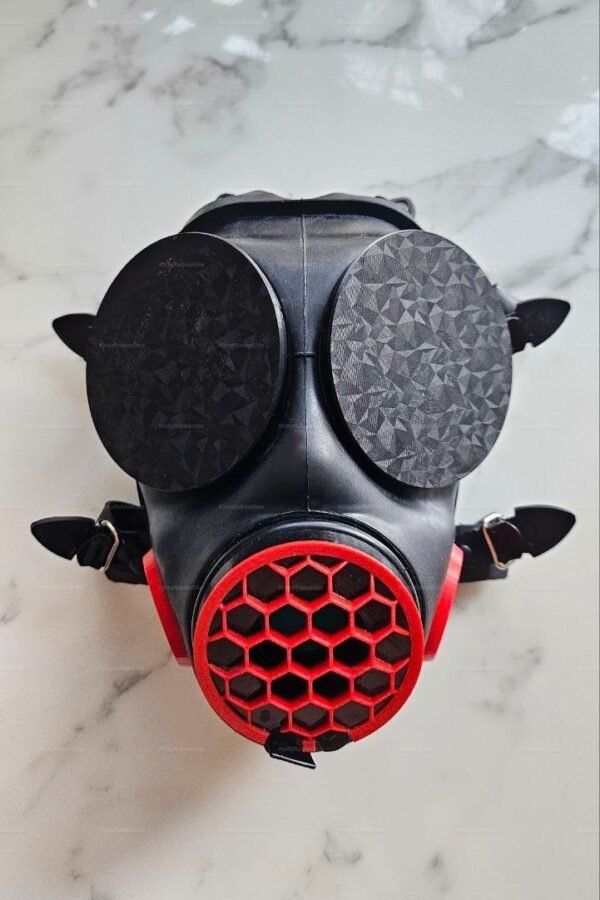 Edgy black and red visor mask with geometric lens design and a striking hexagonal mouthpiece.