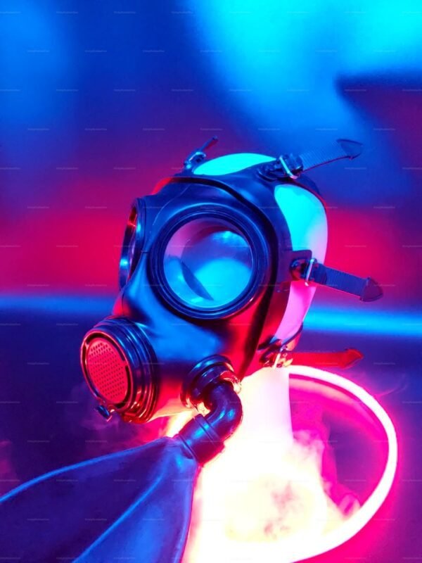 A sleek black rubber gas mask with NATO-compatible fittings, featuring a striking S10 design under vibrant neon lighting.