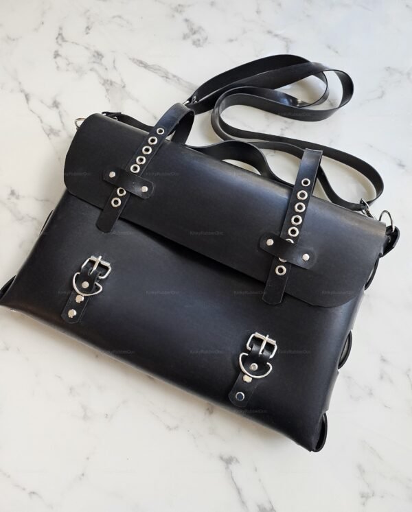 Sleek black rubber bag with buckle and strap details, ideal for alternative fashion enthusiasts.