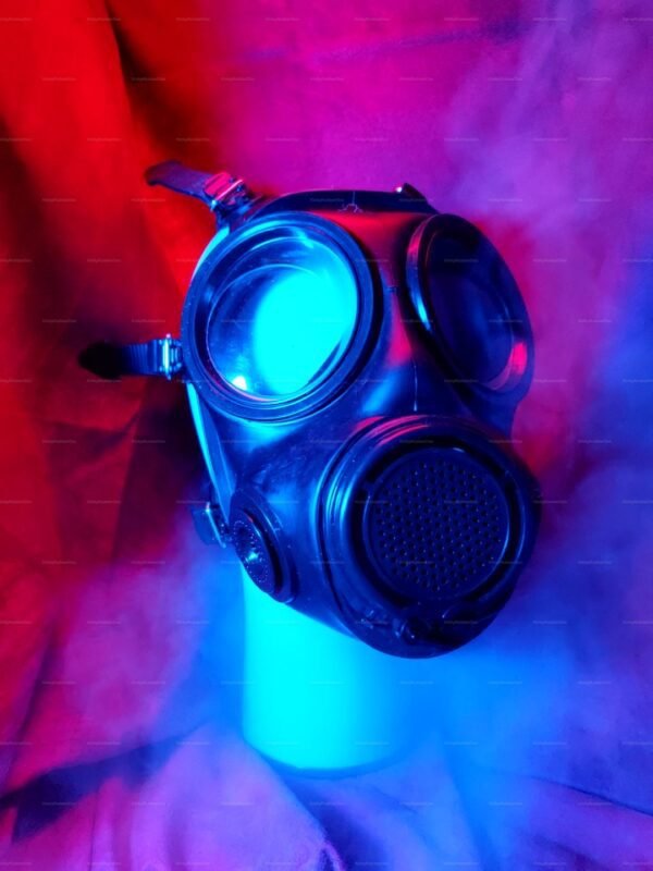 A striking s10 gas mask with a sleek, black rubber finish, highlighted by dramatic red and blue lighting, perfect for cosplay and play.
