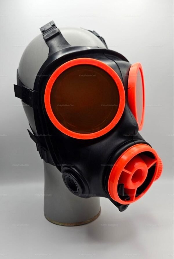 A striking black gas mask with vibrant orange accents, featuring a radiator-inspired design and lens covers.