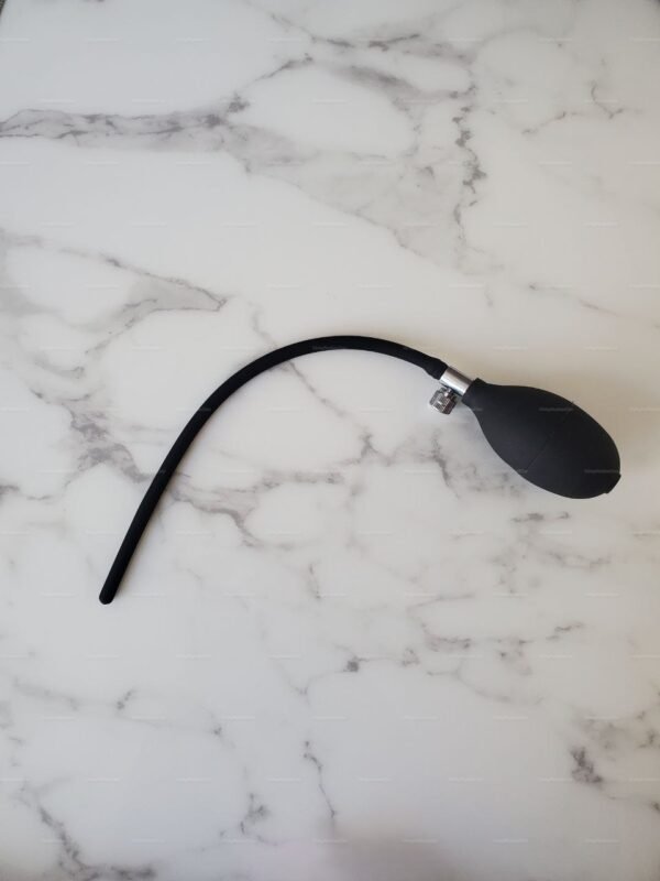 Inflatable Urethral Plug – Playful Catheter Sounding Toy. Black silicone urethral kink toy with a built-in pump on a marble background.