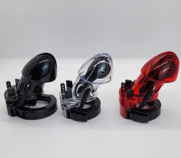 Three transparent chastity cages with electrostimulation features in black, clear, and red, designed for adventurous play.